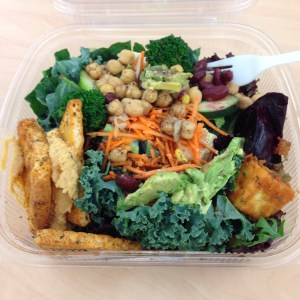 Daily hodge podge salad with kale, raw veggies, tofu, beans, avocado, hummus and pita 